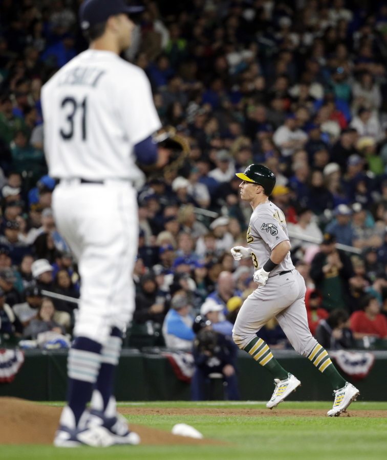 Seattle Mariners relief pitcher Steve Cishek waits as Oakland Athletics&#039; Chris Coghlan rounds the bases on his home run during the ninth inning of a baseball game Friday, April 8, 2016, in Seattle.