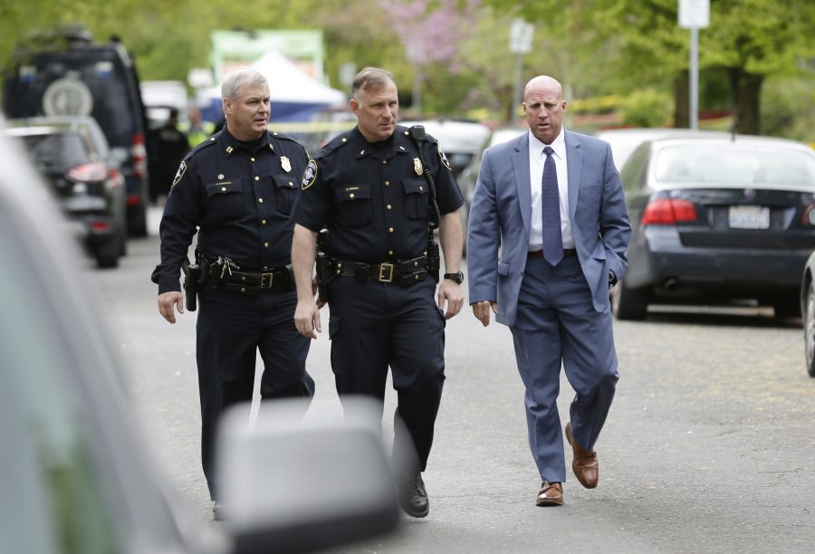 Seattle Police assistant chief Robert Merner, right, walks with other officers Friday after human remains were found in a nearby container in Seattle. Seattle Assistant Police Chief Robert Merner said authorities were investigating the probable connection between the remains found Friday and the recent murder of Ingrid Lyne, whose partial remains were found in a recycling bin earlier in the week. (AP Photo/Ted S.