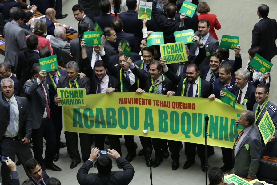 Opposition lawmakers hold a sign that reads in Portuguese &quot;Goodbye dear movement. It&#039;s over&quot; during a debate Friday on whether or not to impeachment President Dilma Rousseff in the Chamber of Deputies in Brasilia, Brazil. The lower chamber of Brazil&#039;s Congress began the debate on whether to impeach Rousseff, a question that underscores deep polarization in Latin America&#039;s largest country and most powerful economy. The crucial vote is slated for Sunday.
