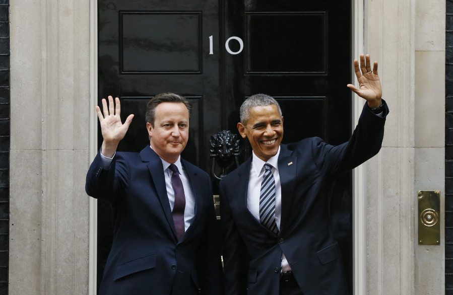 President Barack Obama and Britain's Prime Minister David Cameron wave from the steps of 10 Downing Street, London, before a meeting Friday.