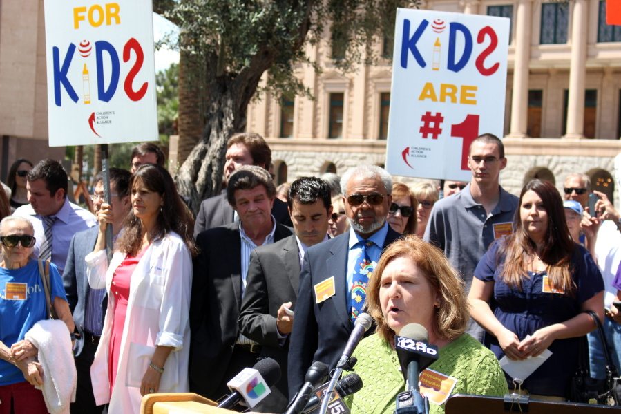 Dana Wolf Naimark of the Children&#039;s Action Alliance speaks Monday at a rally in Phoenix. Wolf urged the Arizona Senate and Gov. Doug Ducey to back a plan restoring a health insurance program called KidsCare for low-income children.