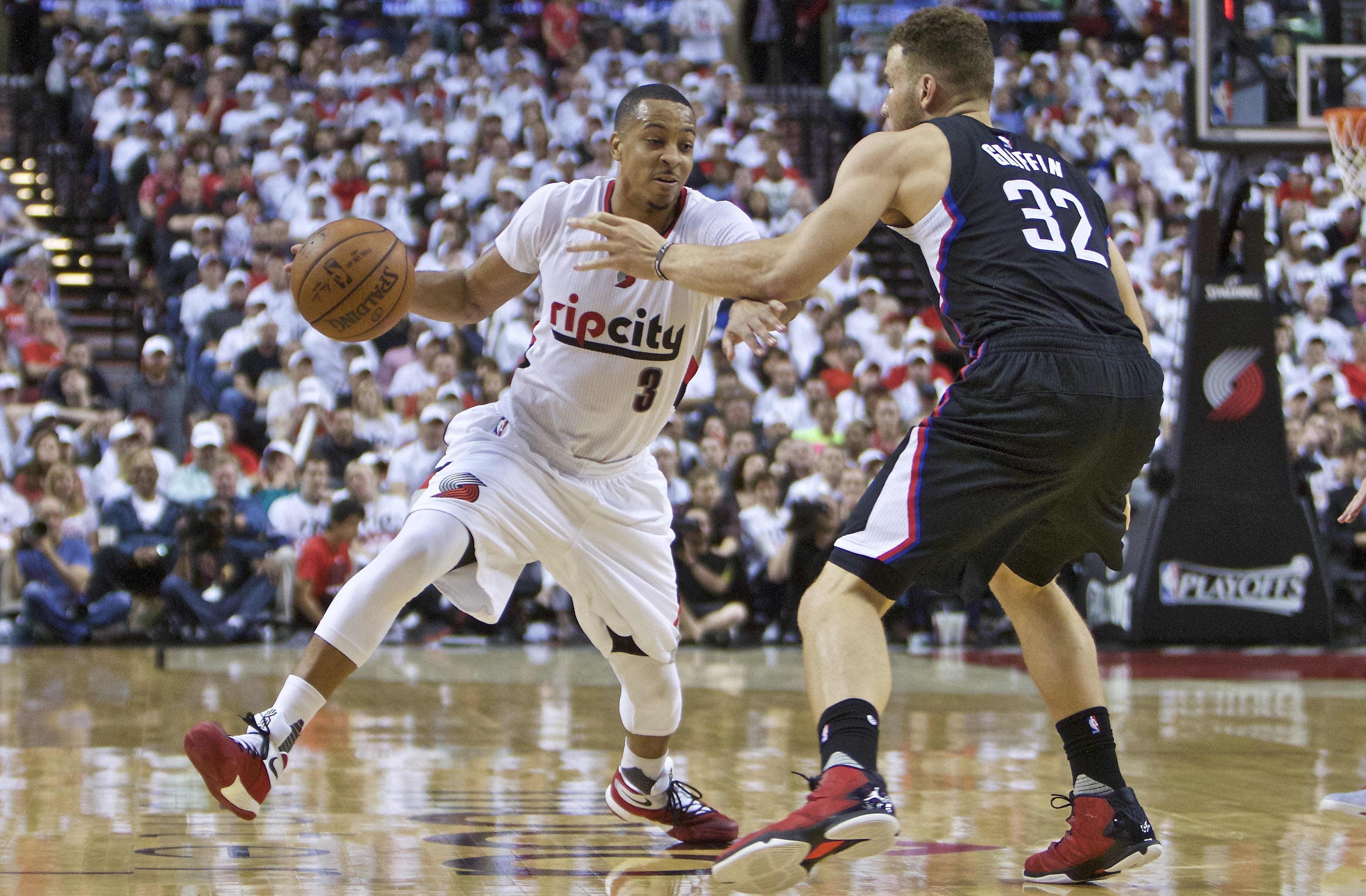 Portland Trail Blazers guard C.J. McCollum, left, dribbles past Los Angeles Clippers forward Blake Griffin, right, during the second half of Game 3 of an NBA basketball first-round playoff series Saturday, April 23, 2016, in Portland, Ore. Portland won 96-88.