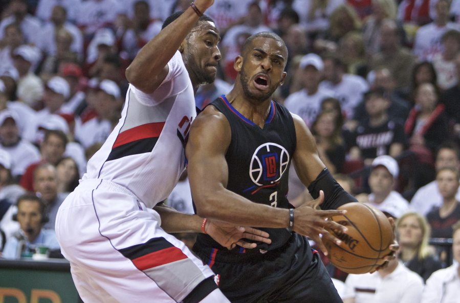 Los Angeles Clippers guard Chris Paul, right, drives to the basket past Portland Trail Blazers forward Maurice Harkless during the first half of Game 3.