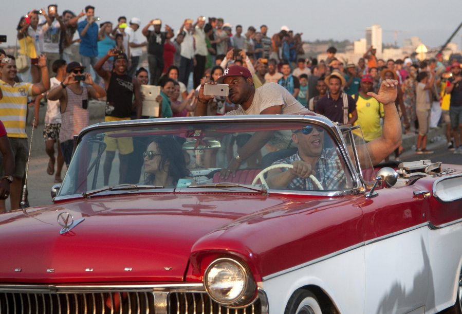 Actor Vin Diesel drives a vintage American car next to actress Michelle Rodriguez on Thursday in Havana after a session of filming for the latest &quot;Fast and Furious&quot; movie.