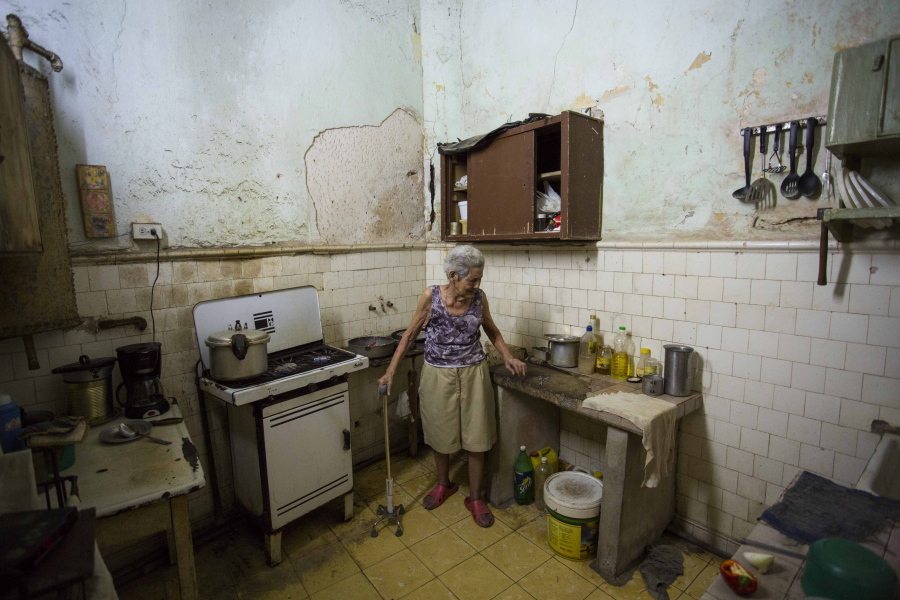 Mercedes Leon, 75, stands in her kitchen on Calle Habana in Old Havana, Cuba, where she lives with her husband and blind son.