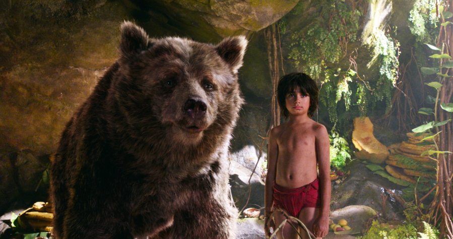 Mowgli, played by Neel Sethi, right, and Baloo the bear, voiced by Bill Murray, appear in &quot;The Jungle Book.&quot; (Disney)