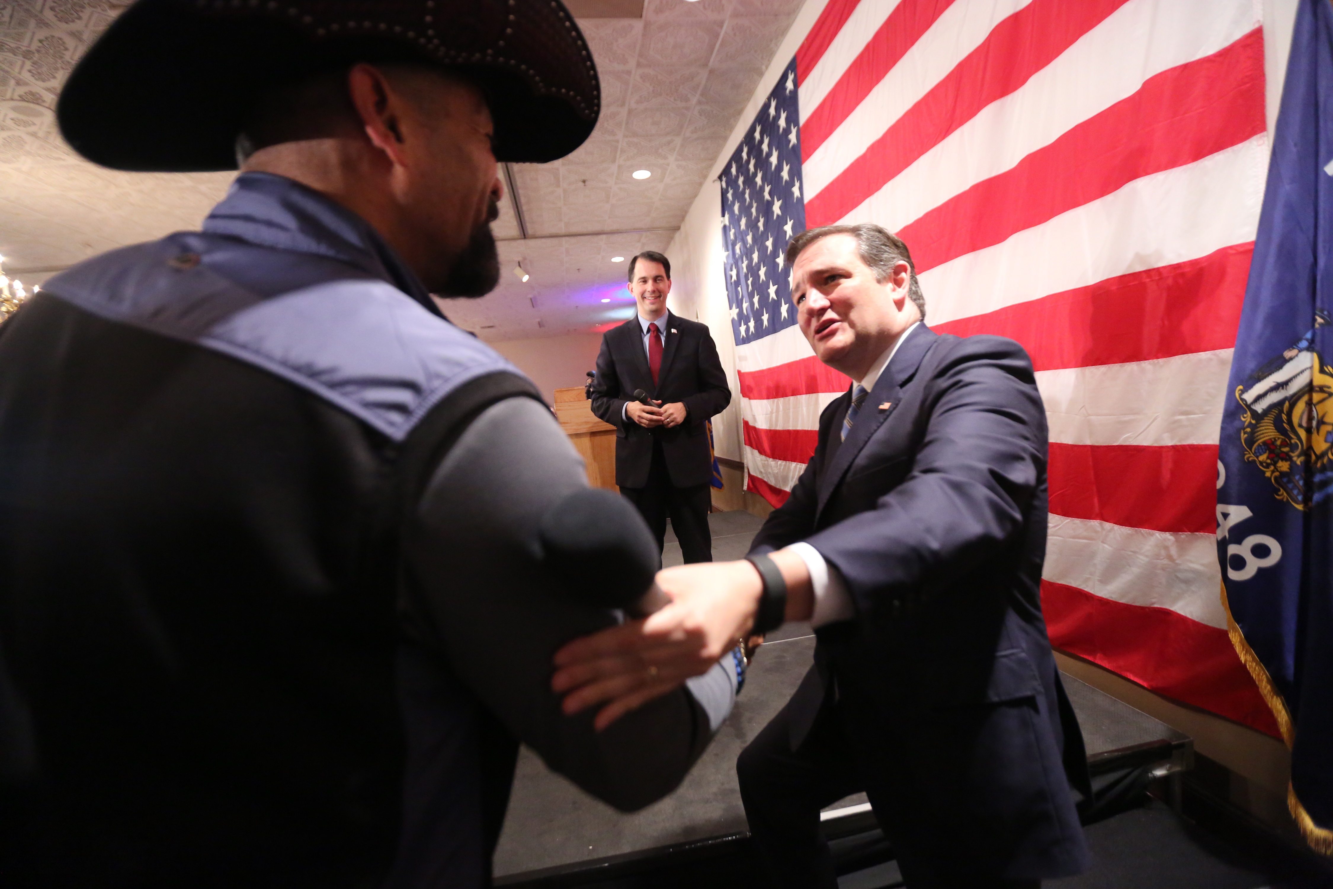 U.S. Sen. Ted Cruz is greeted by Milwaukee County Sheriff David Clark, left, and Gov. Scott Walker before he speaks Friday at a Milwaukee County Republican Party dinner.