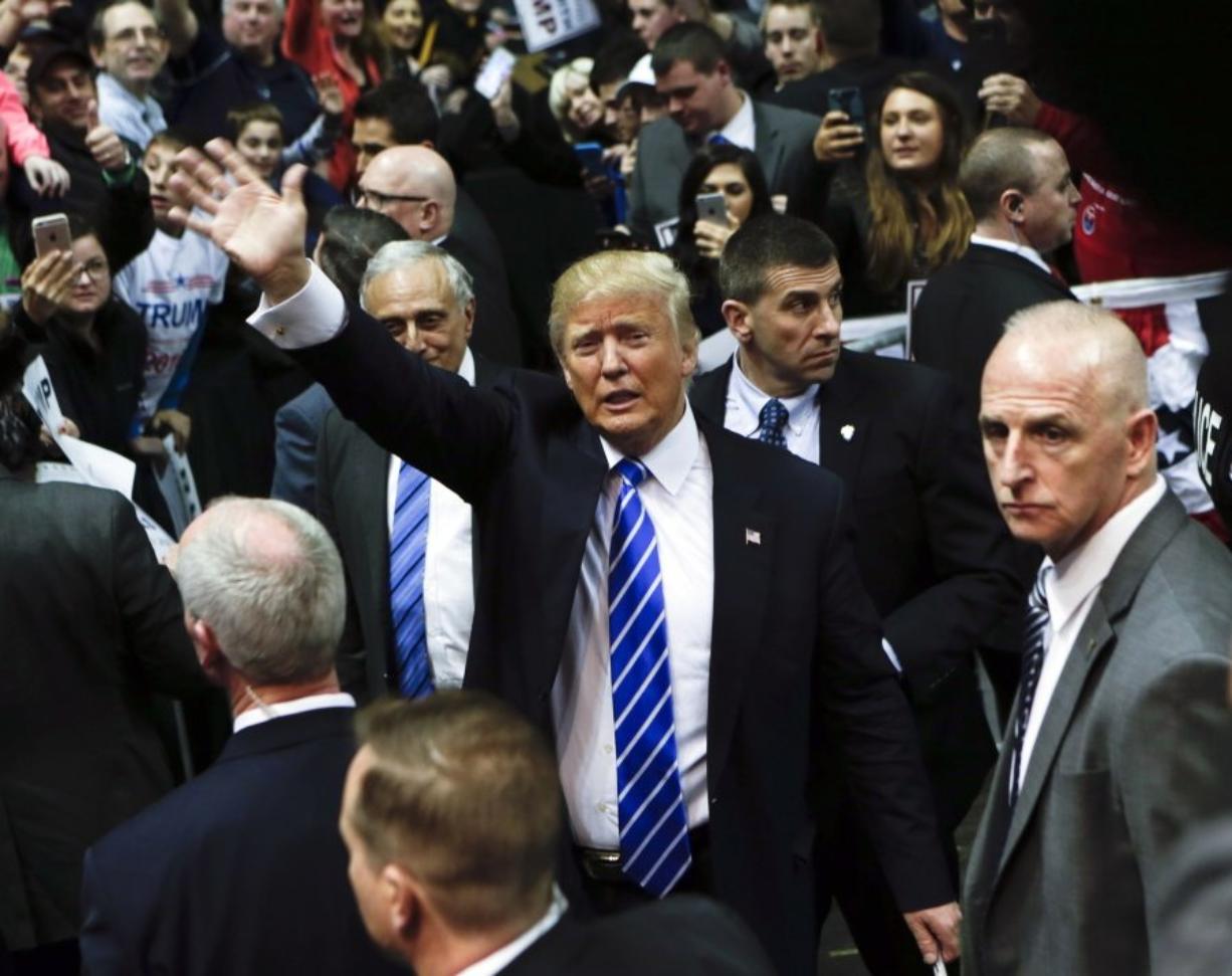 Republican presidential candidate Donald Trump waves after a rally at the Times Union Center on Monday in Albany, N.Y.