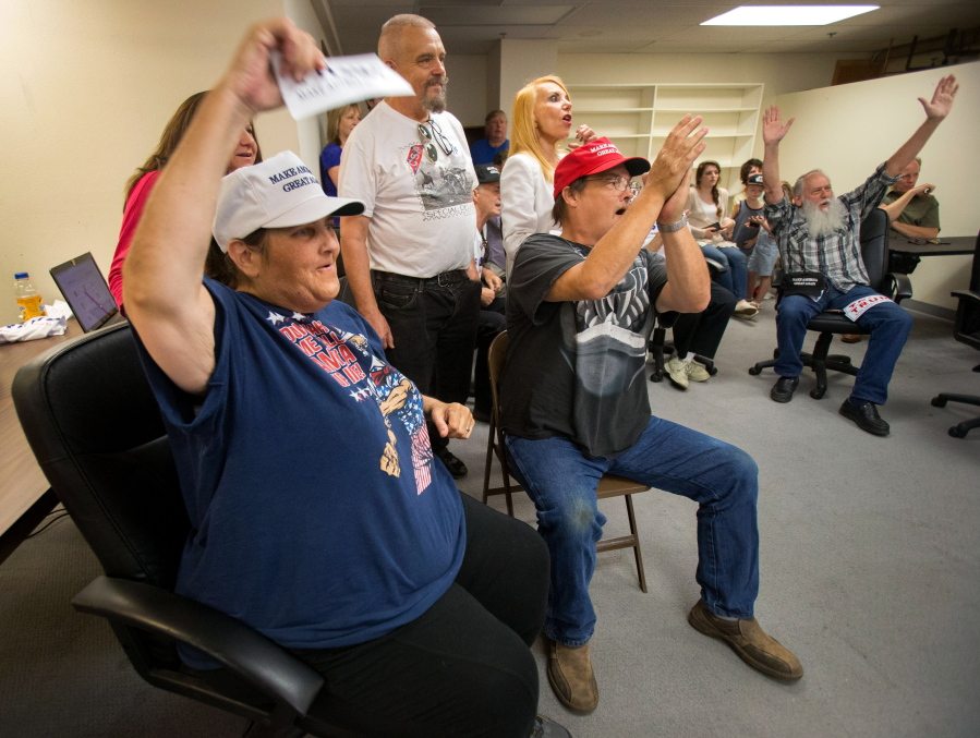 Cheering the results of the New York primary, Carol Bagley of Cottage Grove joins other Trump supporters at the newly-opened campaign office for Donald Trump in Eugene, Ore., on April 19. It is the first official campaign office for the Republican front-runner in the state of Oregon.