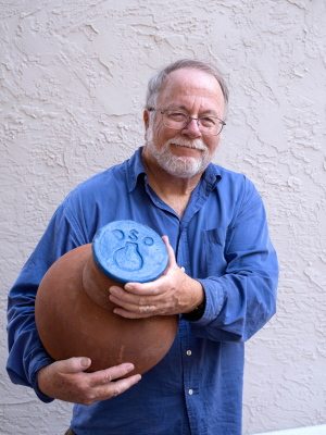 David Bainbridge, author of &quot;Gardening With Less Water,&quot; holds an unglazed clay pot that will move water only to the plants located near it via capillary action. Buried clay pot irrigation is one of the most efficient wearing systems known. Getting water directly to the plants needing it also helps minimize weed growth.