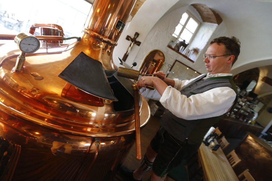 Brewer Michael Gilg controls a sample of wort in his brewery, Griessbraeu, on Thursday in Murnau, Germany.