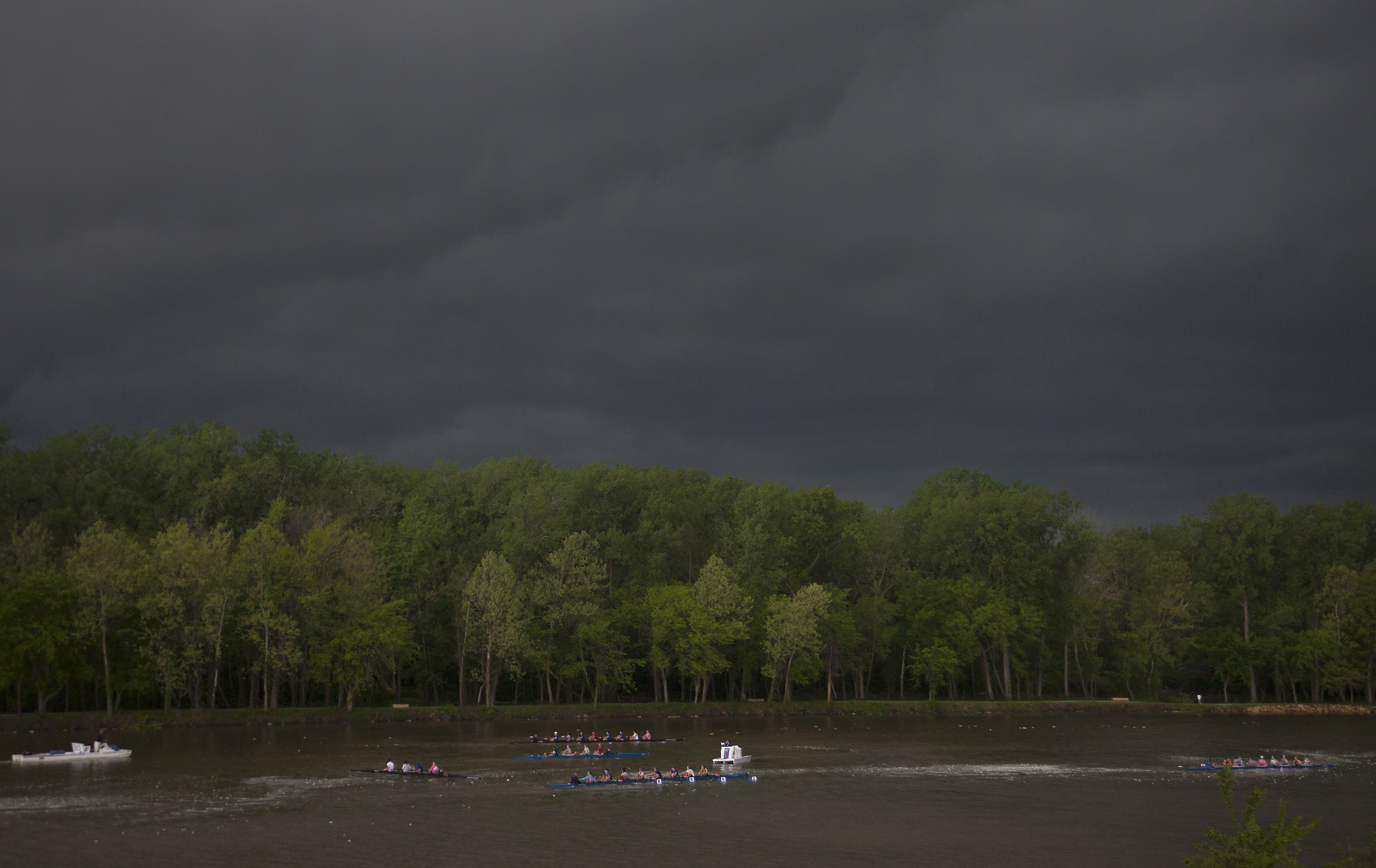 The Kansas University rowing team practices on the Kansas River under threatening clouds as a storm front moves over Lawrence, Kan. early Tuesday morning, April 26, 2016.
