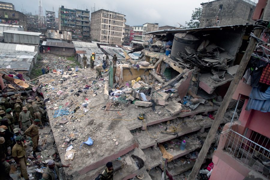 Police and National Youth Servicemen search the site of a six-story building collapse Saturday in Nairobi, Kenya.