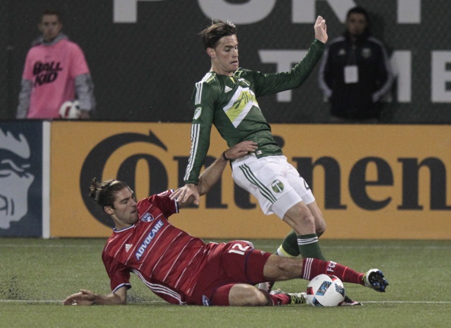 FC Dallas midfielder Ryan Hollingshead, left, and Portland Timbers forward Lucas Melano vie for the ball during the second half of an MLS soccer match in Portland, Ore., Wednesday, April 13, 2016. FC Dallas won 3-1.