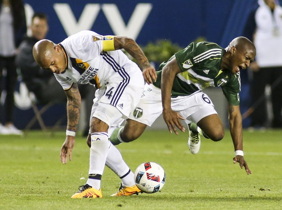 Los Angeles Galaxy midfielder Nigel de Jong, left, crashes into Portland Timbers midfielder Darlington Nagbe during the second half of an MLS soccer game in Carson, Calif., Sunday April 10, 2016. The game ended in a 1-1 draw. (AP Photo/Ringo H.W.