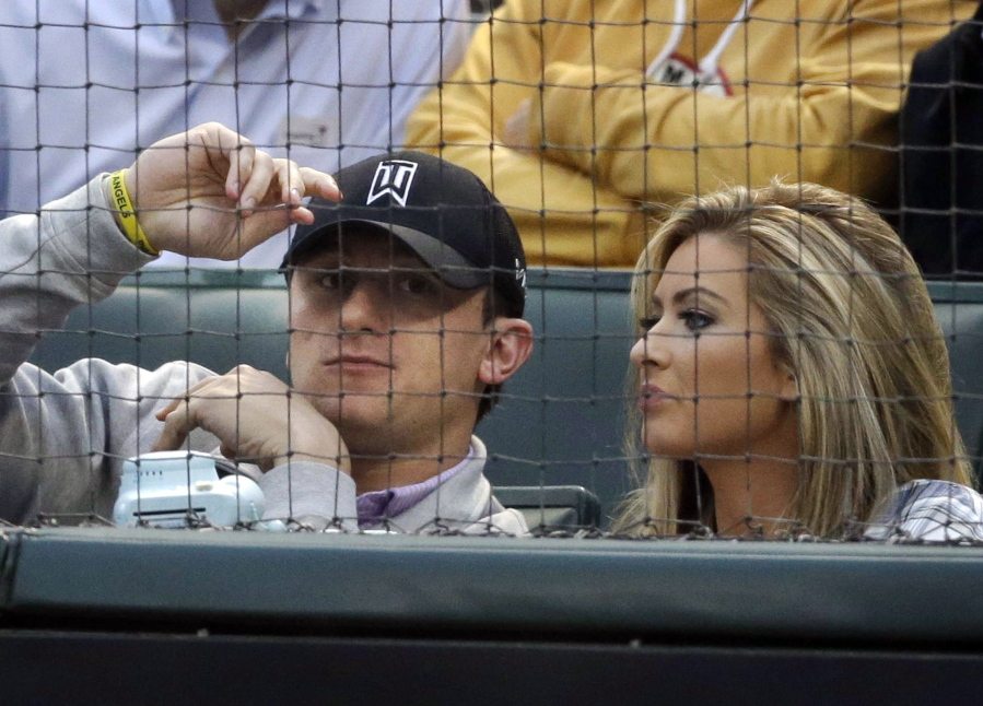 Cleveland Browns quarterback Johnny Manziel, left, sits with Colleen Crowley on April 14, 2015, during a baseball game between the Los Angeles Angels and the Texas Rangers in Arlington, Texas. Manziel was indicted Tuesday on allegations by ex-girlfriend Crowley that he hit her and threatened to kill her in late January.