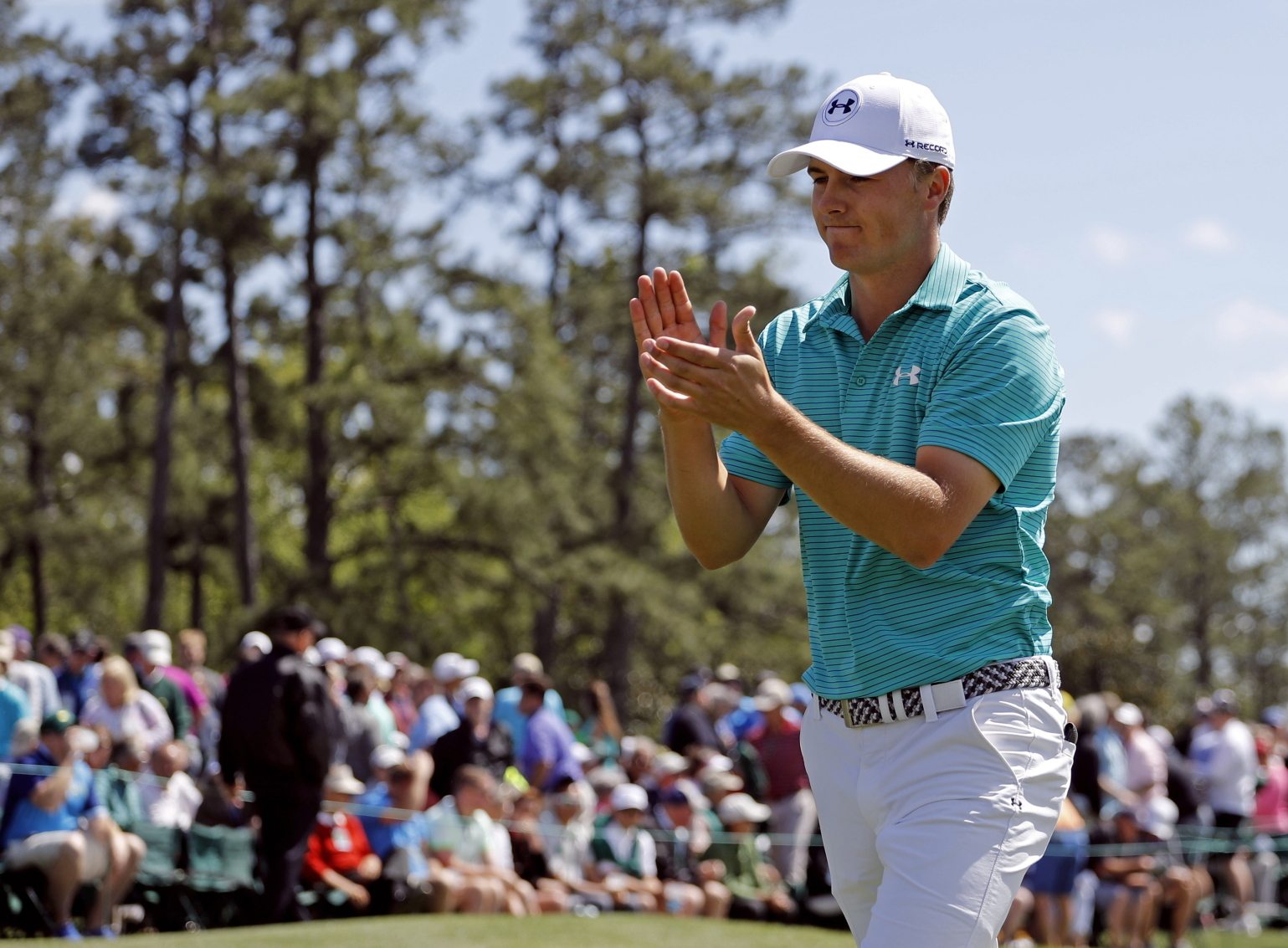Jordan Spieth applauds on the 18th green following his first round of the Masters golf tournament Thursday, April 7, 2016, in Augusta, Ga.