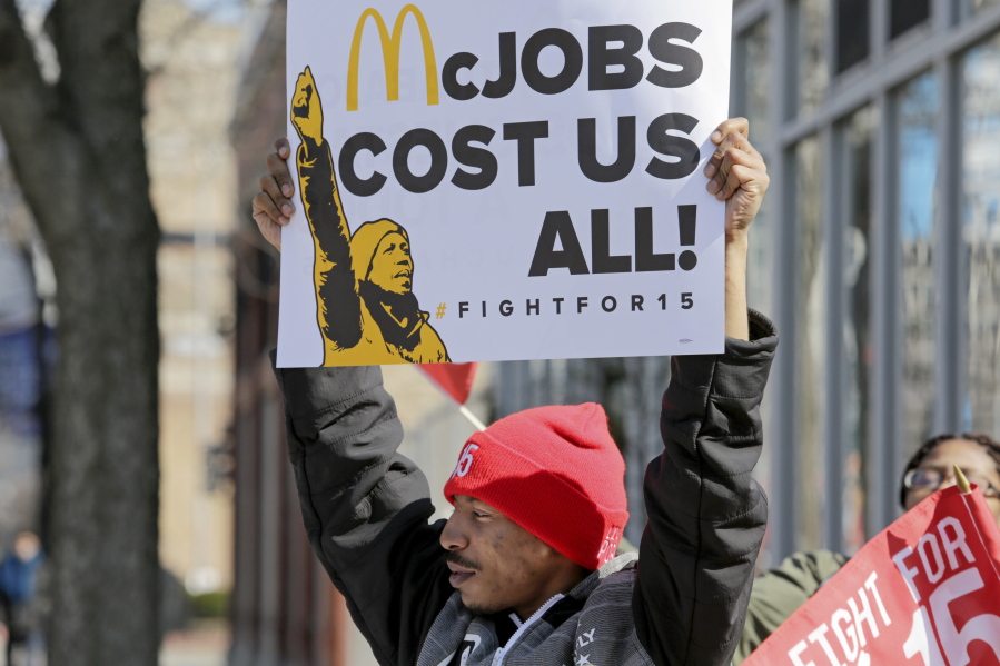 Solo Littlejohn, a fast-food worker from Cicero, Ill., joins protesters calling for unionization and $15 an hour pay Thursday at a McDonald&#039;s restaurant in Chicago.