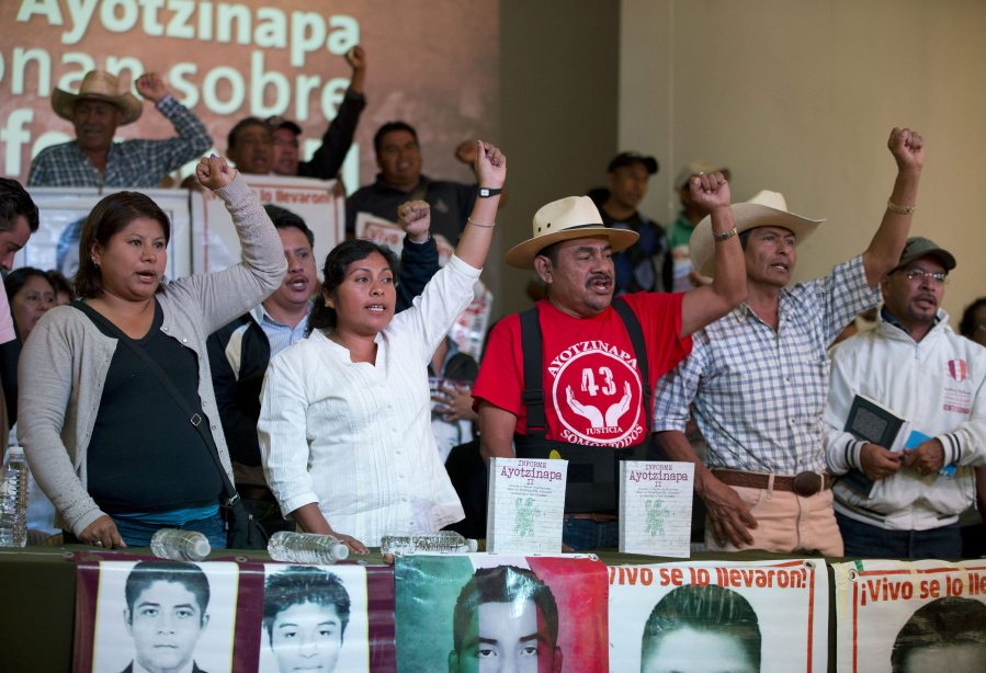 Felipe de la Cruz, center, chants along with parents of some of 43 missing students Monday at a press conference to give the families&#039; response to a report issued Sunday by the Inter-American Commission on Human Rights expert group in Mexico City.