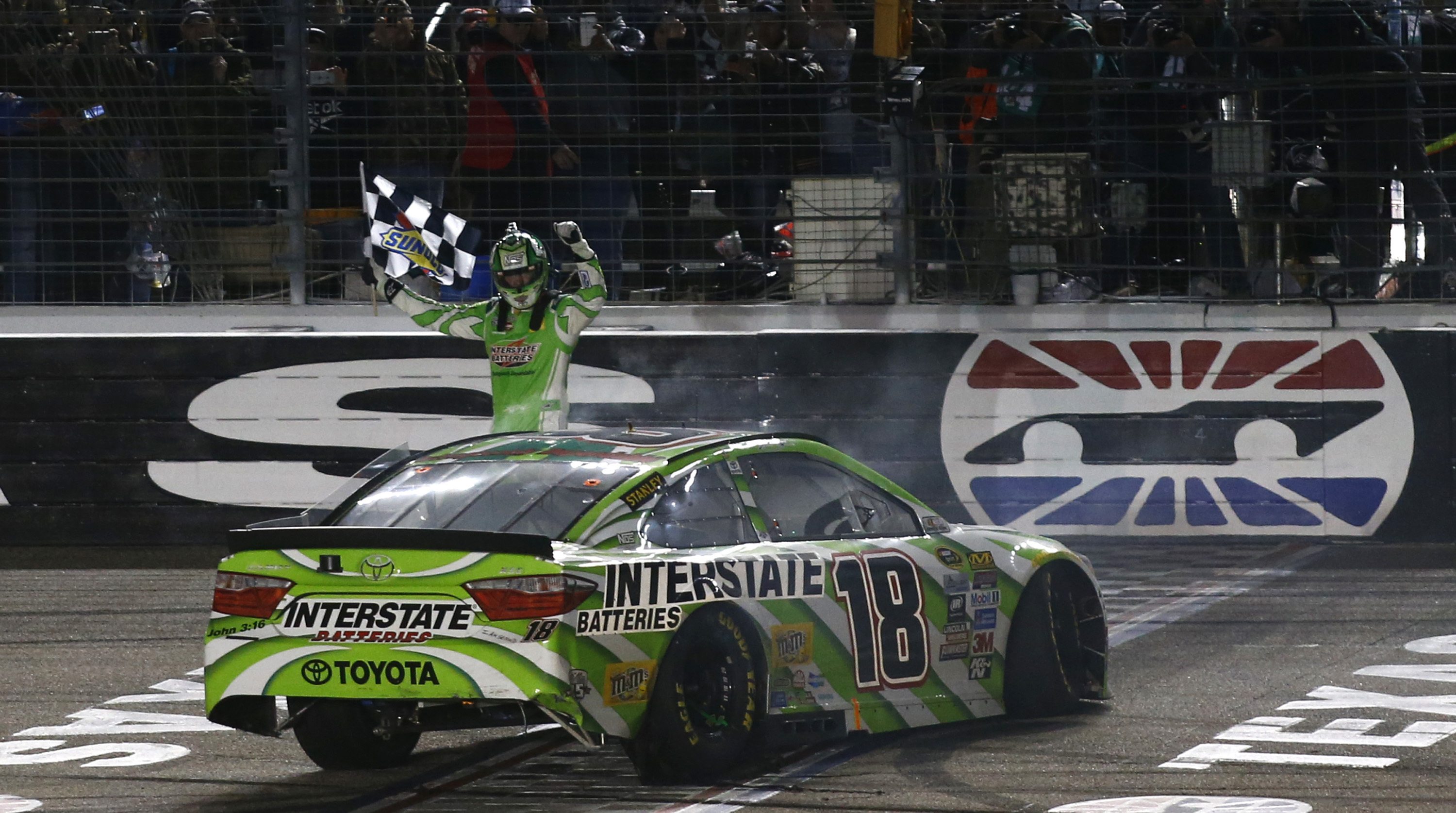 Kyle Busch celebrates after winning the NASCAR Sprint Cup Series auto race at Texas Motor Speedway in Fort Worth, Texas, early Sunday, April 10, 2016.