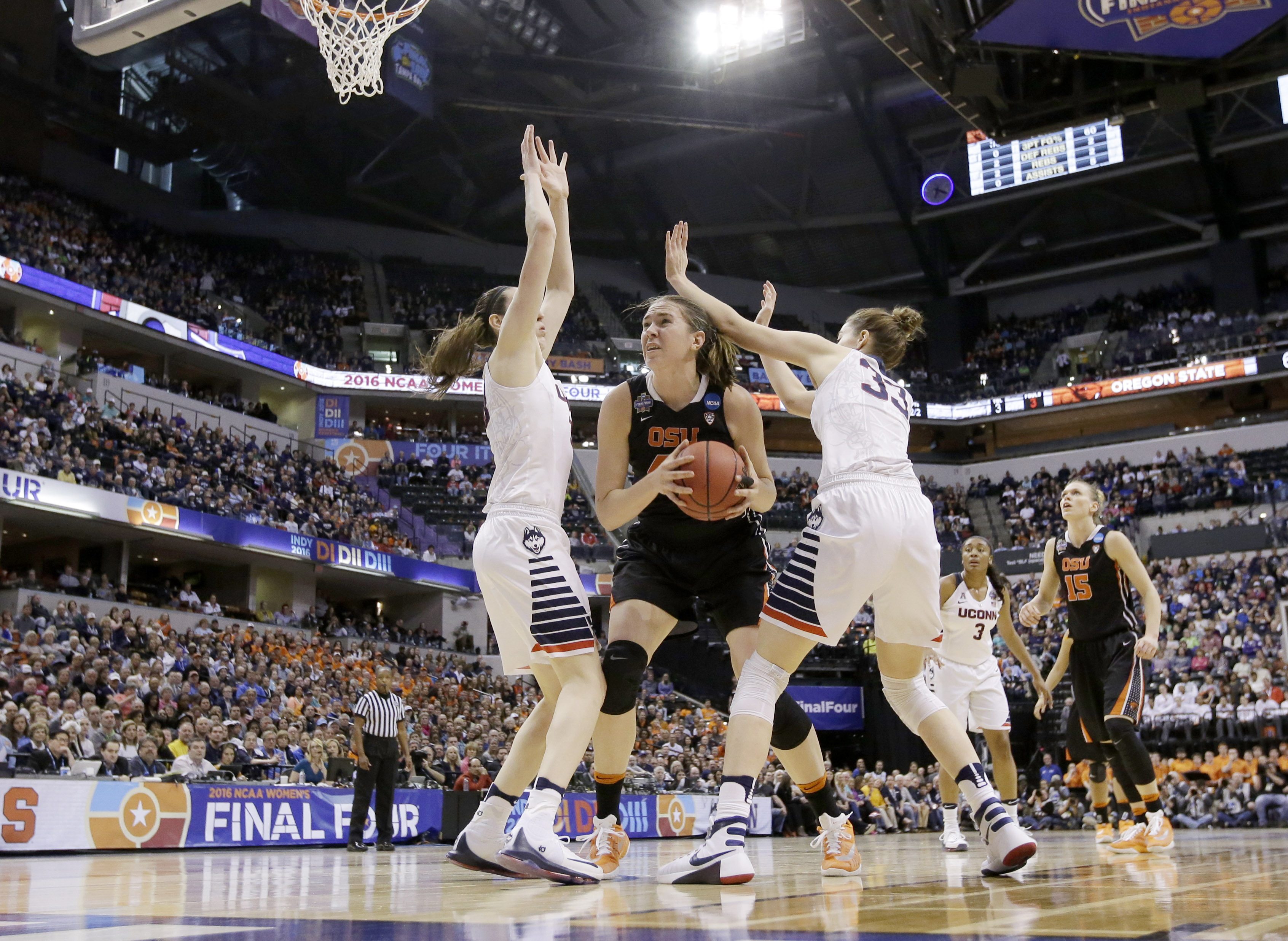 Oregon State's Ruth Hamblin (44) puts up a shot against Connecticut's Breanna Stewart (30) and Katie Lou Samuelson (33) during the first half of a national semifinal game at the women's Final Four in the NCAA college basketball tournament Sunday, April 3, 2016, in Indianapolis.