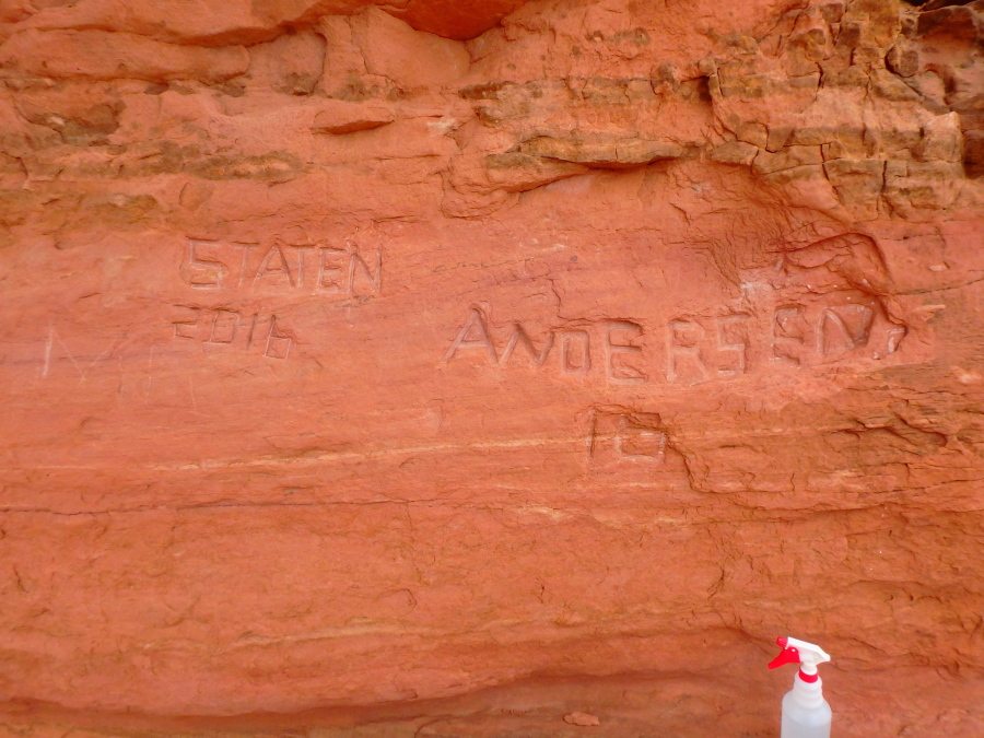 Carved graffiti is seen April 15 at Frame Arch at Arches National Park. Officials at the Utah park are investigating large graffiti carved so deeply into the famous red rock arch that it might be impossible to erase.