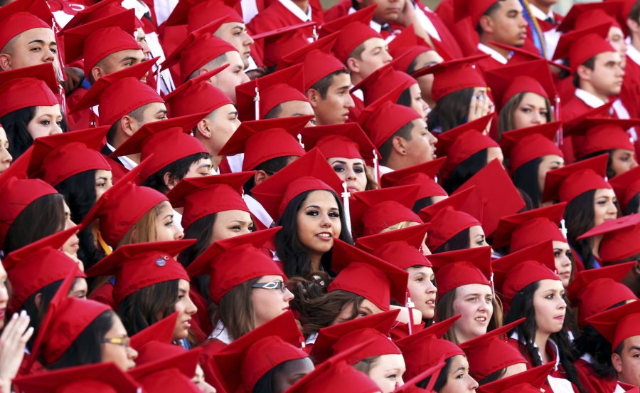 Odessa High School graduates pose for a group portrait prior to the start of the commencement ceremony in Odessa, Texas.