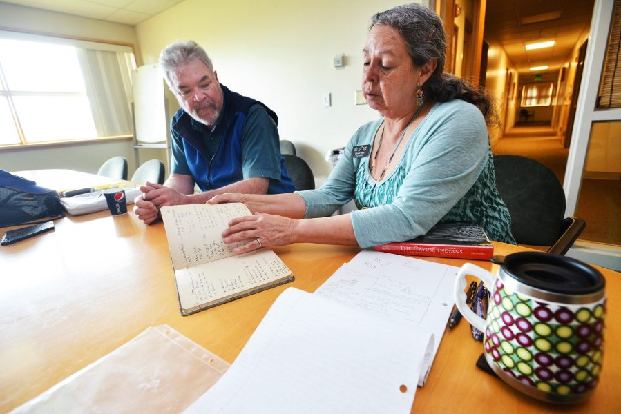 Wes Potter looks on as Tamastslikt Director Roberta Conner thumbs through a ledger owned by his great-grandfather during his time as the Indian agent for the Confederated Tribes of the Umatilla Indian Reservation in the late 1800s. Potter donated the ledger and other historical items owned by his great-grandfather to the Tamastslikt Cultural Institute in Mission. (Photos by E.J.