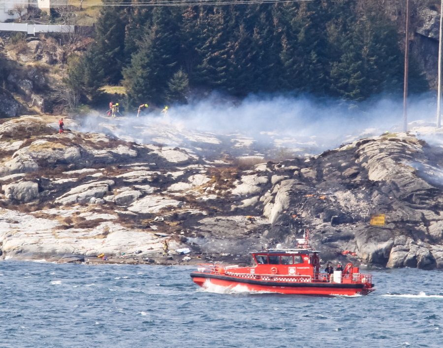 A search and rescue vessel patrols Friday off the coast of the island of Turoey, near Bergen, Norway, as emergency workers attend the scene after a helicopter crashed that killed all 13 people aboard.