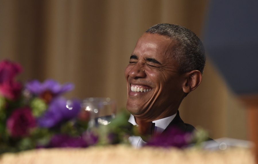 President Barack Obama laughs as he listens to Larry Wilmore, the guest host from Comedy Central, speak Saturday at the annual White House Correspondents&#039; Association dinner at the Washington Hilton.