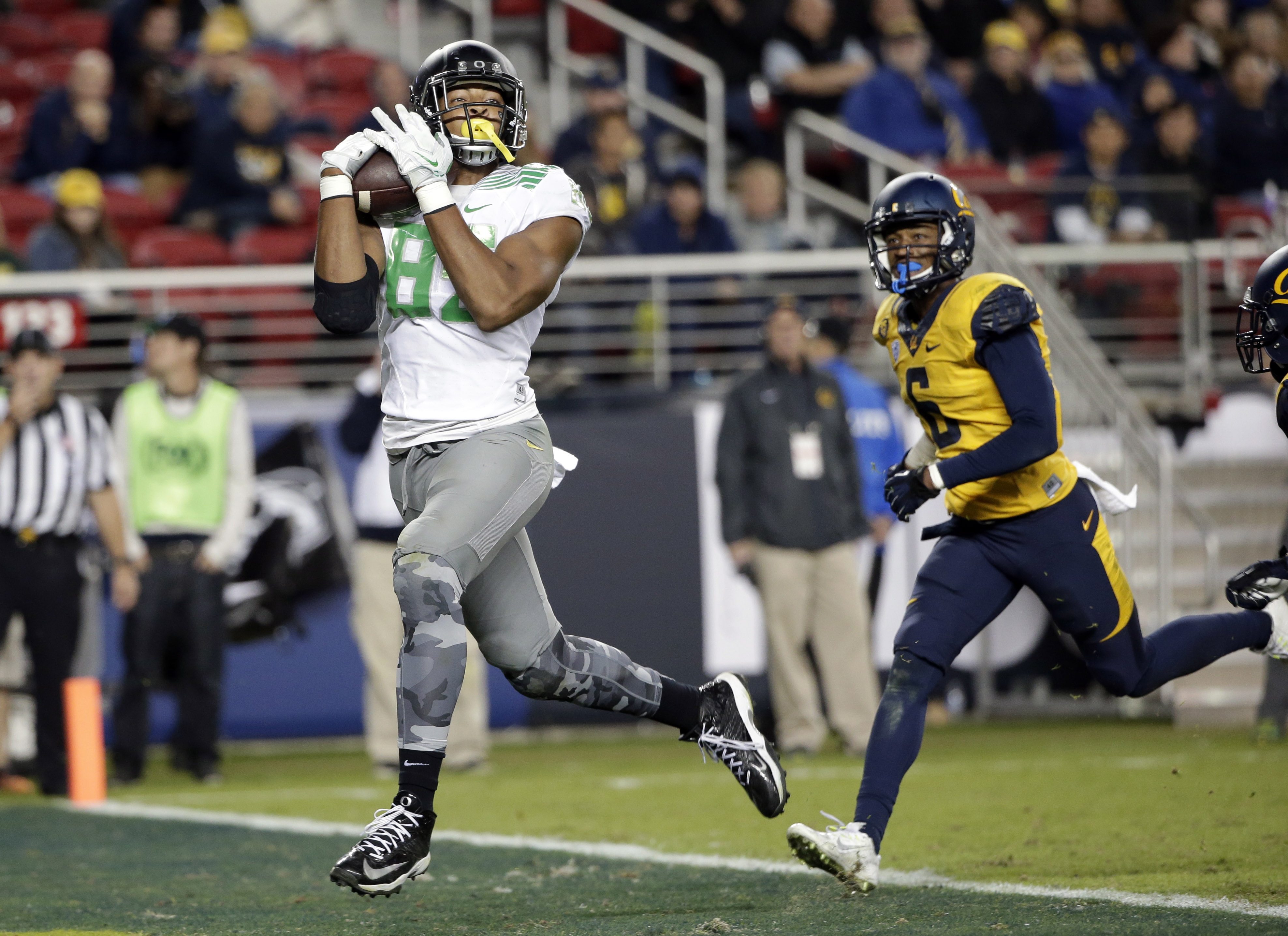 Oregon tight end Pharaoh Brown, left, catches a touchdown pass in 2014. A fluky fall, a near amputation and three surgeries later,  Brown is defying the odds and back with the Oregon Ducks.