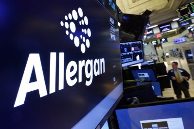 The Allergan logo appears above a trading post on the floor of the New York Stock Exchange.