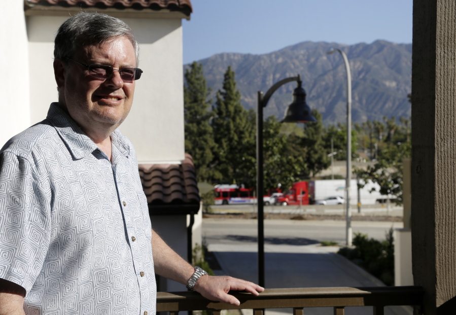 Robert Leviton stands on the balcony of his townhouse in Pasadena, Calif., overlooking the traffic on the stretch of highway that runs alongside his complex. Leviton knew it would be like this when he bought the two-bedroom unit for $666,000 last summer.