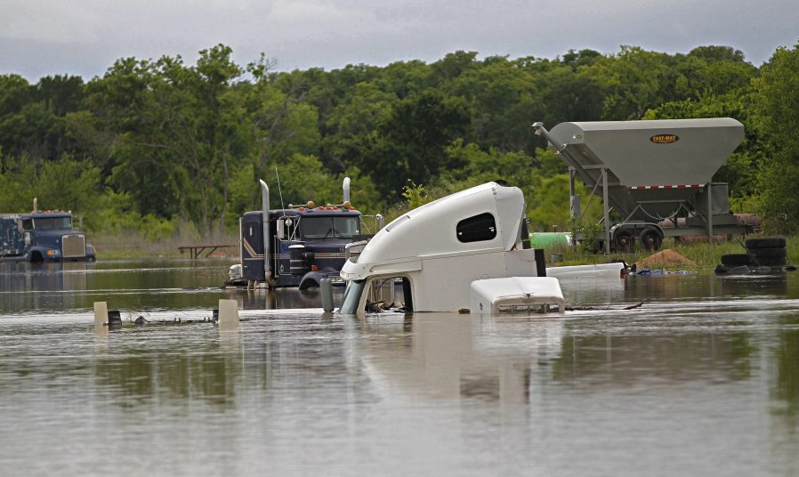 Trucks at a repair shop on Texas Highway 114 are flooded as Lake Bridgeport continued to rise with runoff from recent rains Wednesday in Bridgeport, Texas.