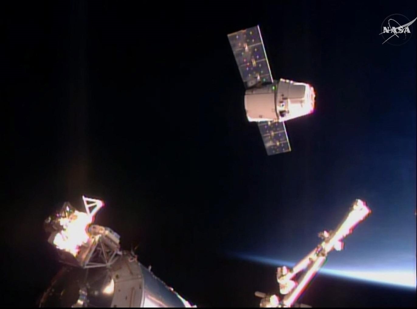 In this frame taken from video from NASA TV, the SpaceX Dragon cargo ship approaches the International Space Station, Sunday April 10, 2016. A SpaceX Dragon cargo ship arrived at the International Space Station on Sunday, two days after launching from Cape Canaveral, Florida. Station astronauts used a big robot arm to capture the Dragon, orbiting 260 miles above Earth.