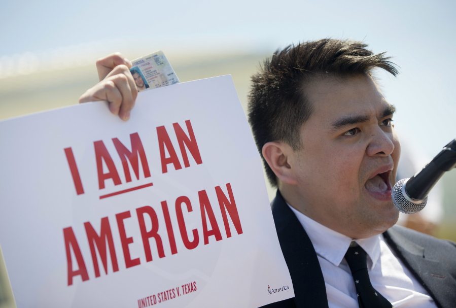 Jose Antonio Vargas, a journalist, filmmaker and immigration rights activist from San Francisco, holds up his California driver&#039;s license as he speaks Monday to supporters of fair immigration reform gather in front of the Supreme Court in Washington.