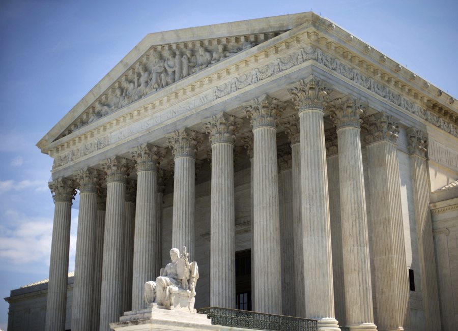 The Supreme Court building is seen in Washington. The Supreme Court on Friday rejected an emergency appeal to stop Texas from enforcing its challenged voter ID law. But the court said it could revisit the issue as the November elections approach.