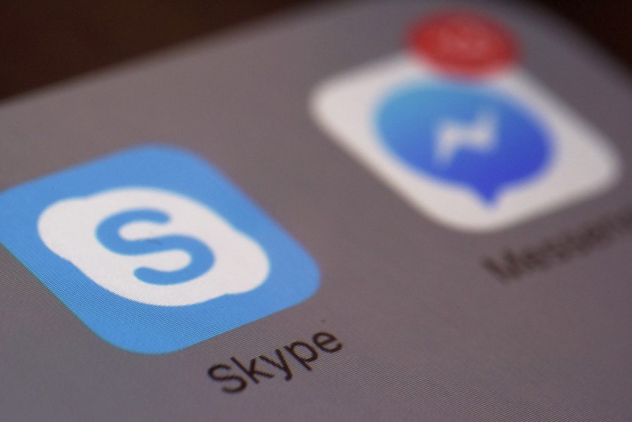 The icons for Microsoft&#039;s Skype and Facebook&#039;s Messenger apps on a smartphone.