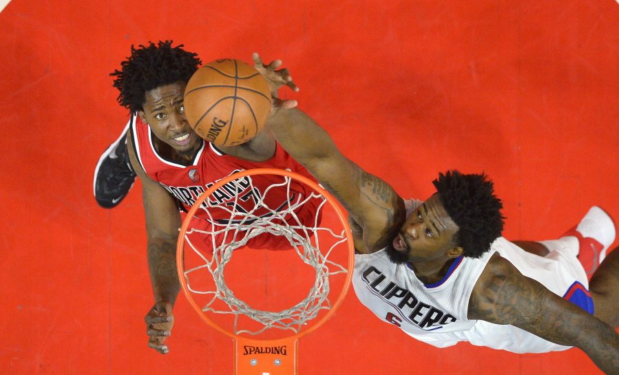 Portland Trail Blazers center Ed Davis, left, and Los Angeles Clippers center DeAndre Jordan reach for a rebound during the first half in Game 5 of a first-round NBA basketball playoff series, Wednesday, April 27, 2016, in Los Angeles. (AP Photo/Mark J.