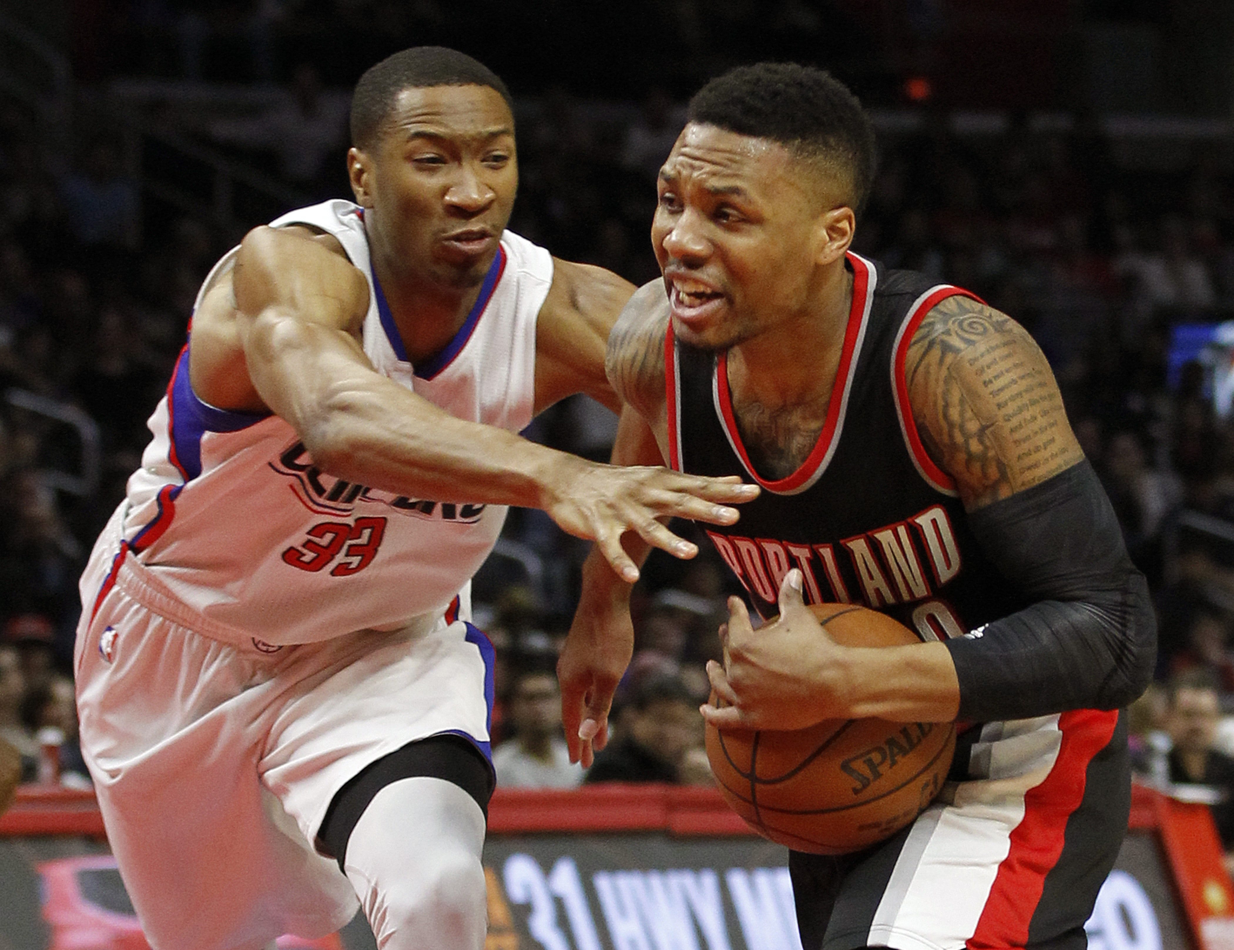 Portland's Damian Lillard, right, drives against Los Angeles Clippers' Wesley Johnson, left, during their game on March 24, 2016. The Clippers won this game 96-94, and could see the Blazers again in the first round of the NBA playoffs.