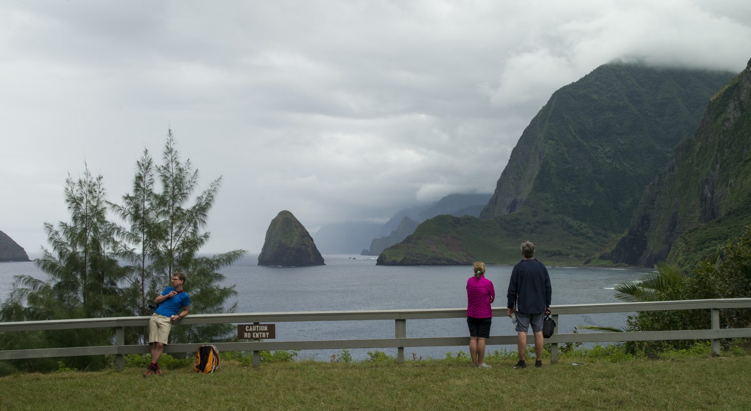 Hikers overlook a bluff on the Kalaupapa Peninsula in Kalawao, Hawaii. A visit to the island of Molokai offers a window on a unique and tragic chapter of Hawaiian history.