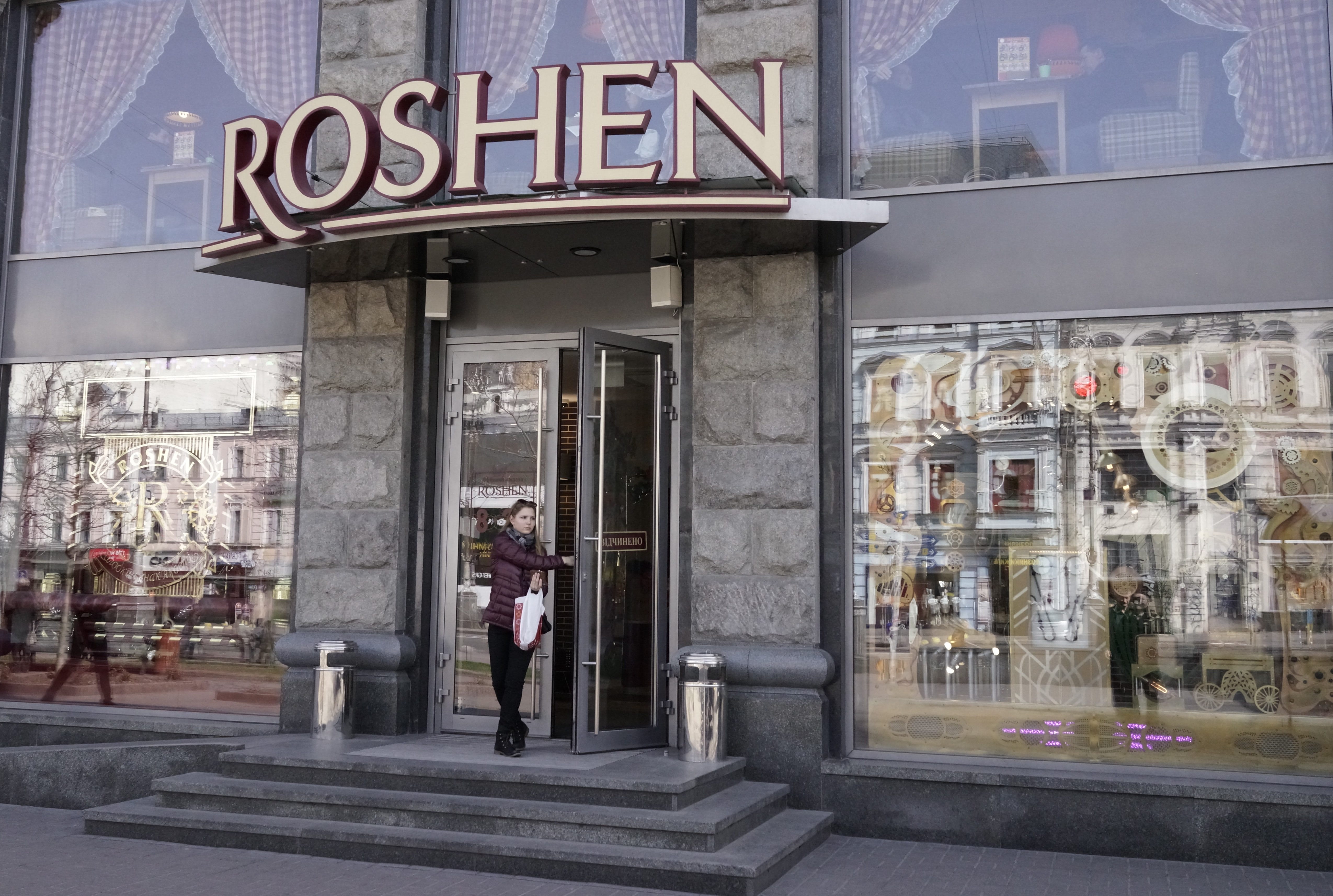 A woman exits a Roshen shop in Kiev, Ukraine, Monday, April 4, 2016. Poroshenko has found himself amid a perfect political storm over the leaked documents from a Panamanian firm pointing at his offshore assets, with some of his political adversaries calling for his removal from office. Ukrainian President Petro Poroshenko?s advisers have insisted that the offshore business was part of corporate restructuring intended to facilitate the eventual sale of Roshen assets.