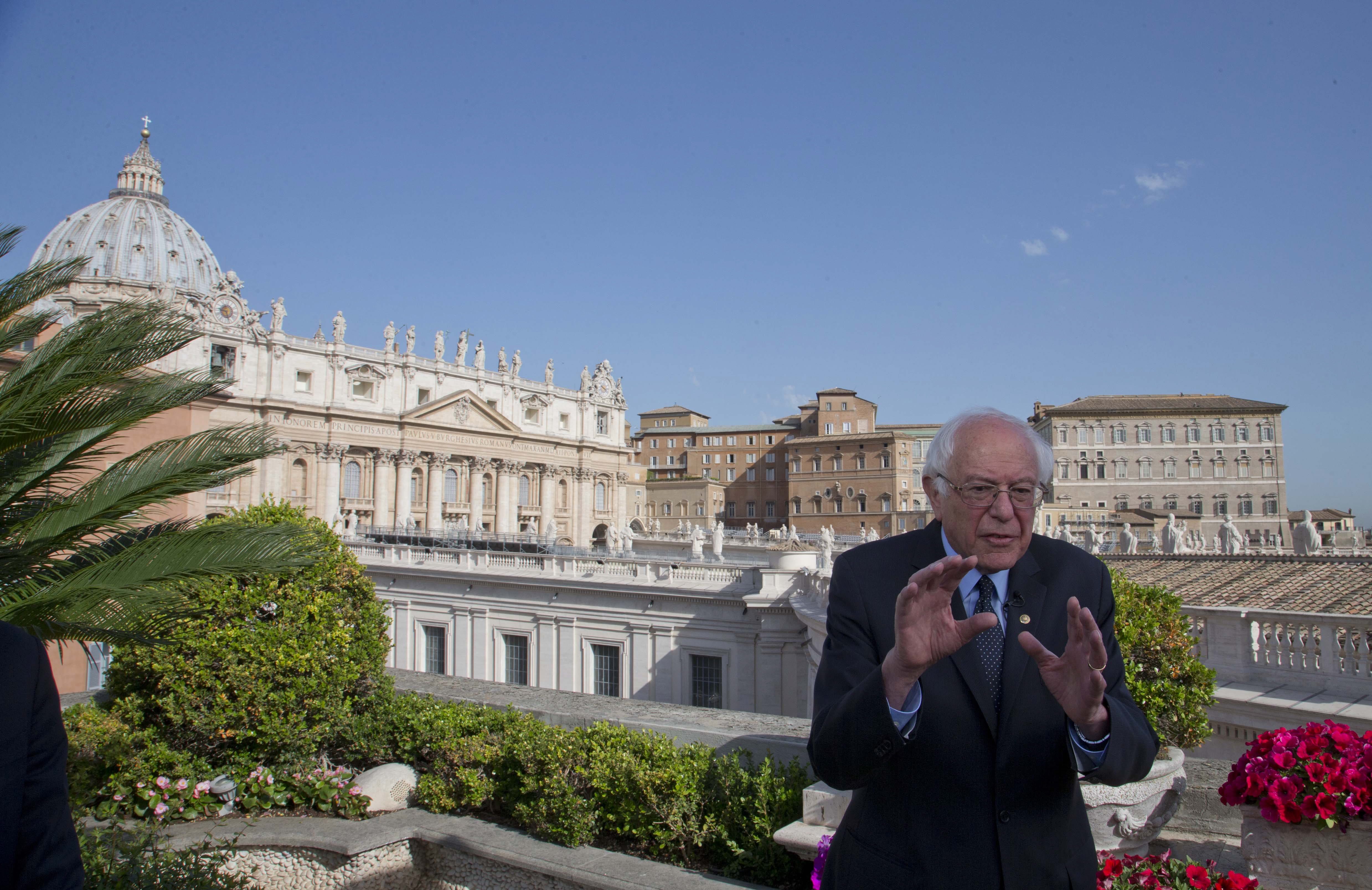 US presidential candidate Bernie Sanders, backdropped by St. Peter's Basilica, talks during an interview with the Associated Press, at the Vatican Saturday, April 16, 2016. Democratic presidential candidate Bernie Sanders says in an interview with The Associated Press that he met with Pope Francis. Sanders says the meeting took place Saturday morning before the pope left for his one-day visit to Greece. He says he was honored by the meeting, and that he told the pope he appreciated the message that he is sending the world about the need to inject morality and justice into the world economy.