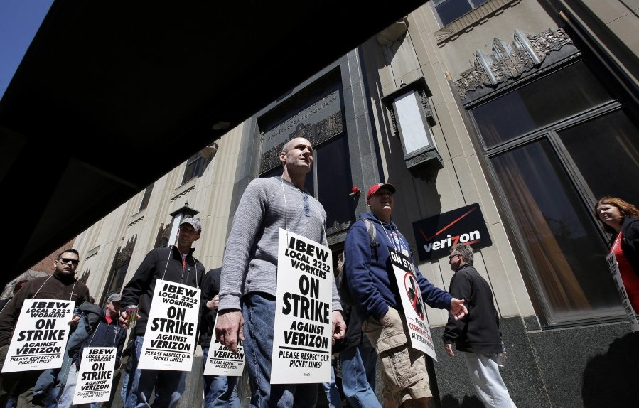 Verizon workers picket outside one of the company&#039;s facilities Wednesday, April 13, 2016, in Boston. Members of the Communications Workers of America and the International Brotherhood of Electrical Workers went on strike Wednesday morning.