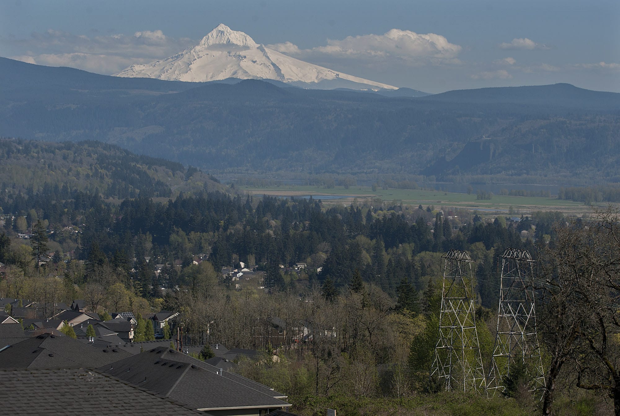 High-voltage power lines, right, are seen in April from a Camas residence. BPA has made a public request for offers on products or methods that could help reduce the congestion in its electrical transmission lines in Southwest Washington and Northwest Oregon.
