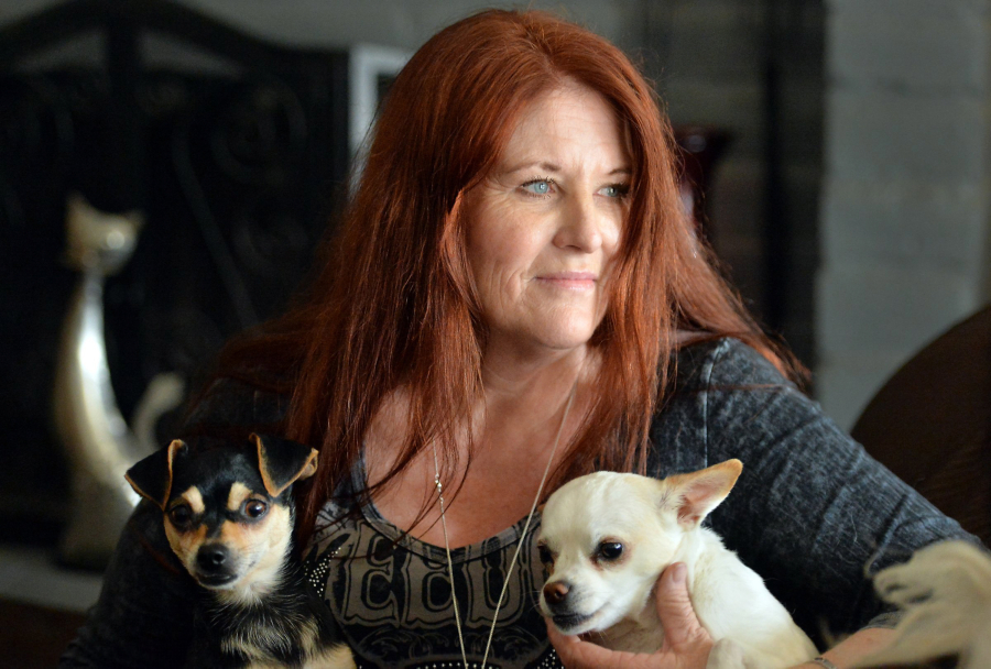 Laura Gordon, with two of her own dogs, Luke, left, and Nicki Sixx, at home in Madera, Calif., on Friday, April 22, 2016. Gordon writes dog bios for Labrador Retriever Rescue of Fresno from the viewpoints of the dogs.