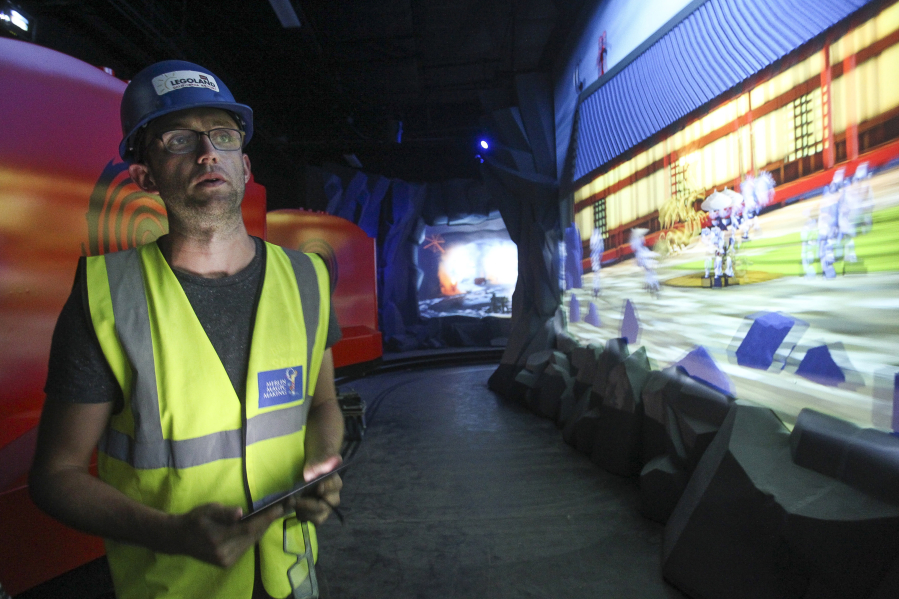 Project manager Chris Brzezicki looks at 3-D projections with which children will be able to interact while on the Ninjago ride at Legoland in Carlsbad, Calif.
