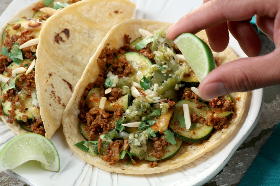To build that taco, start with filling, then salsa, then finishing toppings, such as the cilantro and slivered almonds in our zucchini, chorizo and almond tacos.