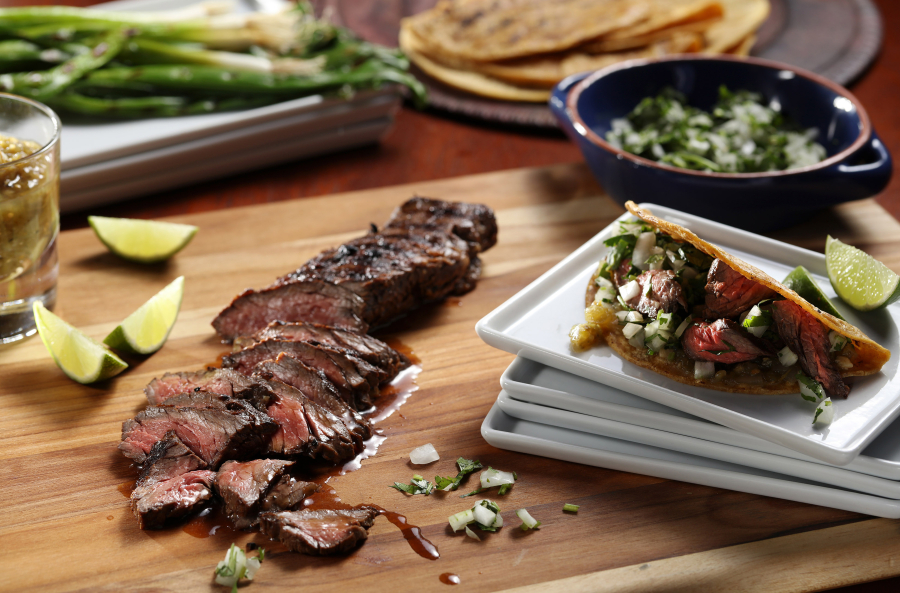 Skirt steak spends time in a lime and garlic marinade before it&#039;s seared on the grill for carne asada tacos.