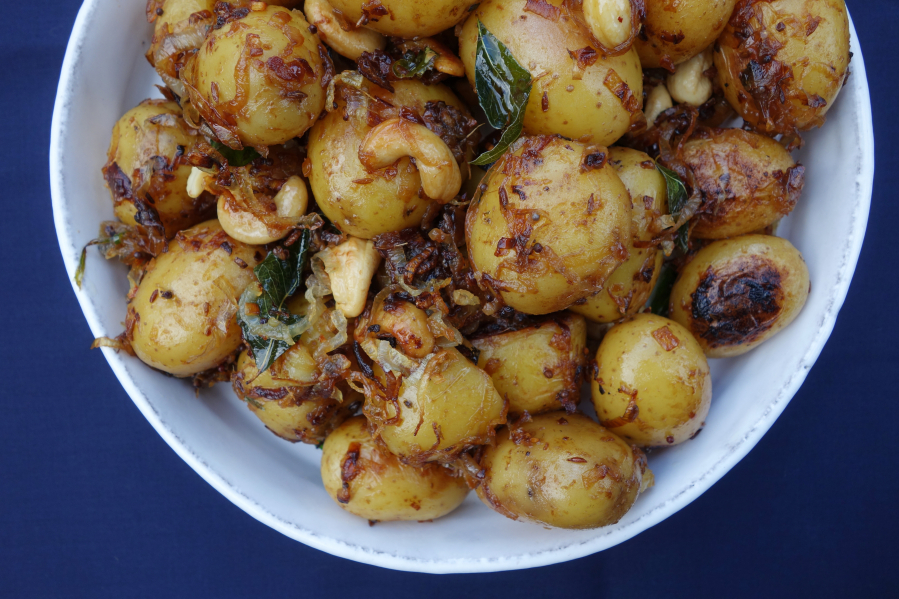 South Indian potatoes are a distant, more tropical cousin of the classic potato salad but embellished with coastal Indian ingredients: crispy shallots, a few spices, crunchy golden cashews and a little coconut milk.